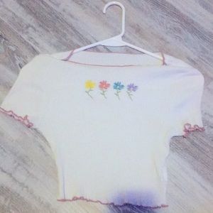 I am selling a cropped T-shirt it has adorable little flowers on it